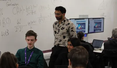 Iman Hussain teaching in a classroom